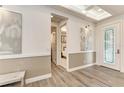 Bright foyer with wood-look floors, elegant lighting, and decorative wall trim at 260 Van Gogh Cv, Bradenton, FL 34212