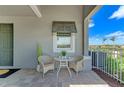 Inviting outdoor seating area with table, two chairs, window, and a view at 264 Van Gogh Cv, Bradenton, FL 34212