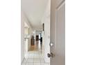 Bright entryway featuring white tiled floors, a view of the living area, and neutral paint at 2774 71St St Ct W # 2101, Bradenton, FL 34209