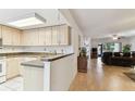Open kitchen featuring laminate countertops, tiled floors, and a view of the spacious living room at 2774 71St St Ct W # 2101, Bradenton, FL 34209