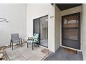 Cozy patio features a tiled floor with outdoor seating and entry to the home through a sliding glass door at 2774 71St St Ct W # 2101, Bradenton, FL 34209