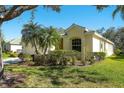 Attractive one-story home with lush landscaping, large trees, and manicured lawn, creating excellent curb appeal at 3116 Woodland Fern Dr, Parrish, FL 34219