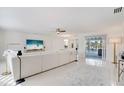 Bright living room featuring white walls, modern furnishings, and sliding glass doors to the outdoor pool area at 329 Avenida Leona, Sarasota, FL 34242