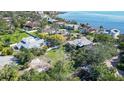 Neighborhood aerial view showcasing waterfront houses, mature trees, and lush lawns at 4003 Bayside Dr, Bradenton, FL 34210