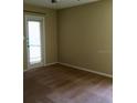Neutral-toned bedroom featuring a door to the outside and neutral carpet at 4008 Crockers Lake Blvd # 11, Sarasota, FL 34238