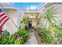 A welcoming entrance, featuring lush landscaping and a stylish pergola, creating a charming curb appeal at 4050 Oakhurst Dr # 3175, Sarasota, FL 34233