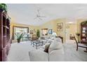 Bright and airy living room featuring neutral tones, plush carpeting, and ample natural light at 4050 Oakhurst Dr # 3175, Sarasota, FL 34233