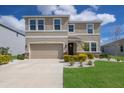 Charming two-story home featuring a well-maintained lawn and beautiful landscaping around the front at 411 158Th E St, Bradenton, FL 34212
