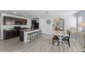 Open-concept kitchen featuring stainless steel appliances, large island, and dining area at 4205 Willow Hammock Dr, Palmetto, FL 34221