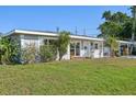 A charming single-story home with a freshly painted exterior, well-manicured lawn, and mature landscaping at 4335 Maceachen Blvd, Sarasota, FL 34233