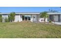 Close-up of a charming single-story home with a freshly painted exterior and well-manicured lawn and landscaping at 4335 Maceachen Blvd, Sarasota, FL 34233
