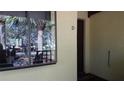 View of condo entrance with large window, dark door with the letter 'D' on it, and a decorative welcome mat at 4412 Spicewood Dr # D, Bradenton, FL 34208