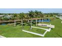 Picturesque view of the Esplanade community entrance with lush landscaping, lake, and palm trees at 4721 Tortona Ct, Bradenton, FL 34211