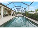 Stunning screened-in pool with an attached spa and a spacious deck for entertaining guests at 4813 Sparkling Sea Ln, Lakewood Ranch, FL 34211