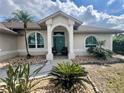 Inviting front entrance with decorative pillars and lush landscaping at 503 Philodendron, Punta Gorda, FL 33955