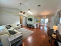 Bright living room with hardwood floors, a ceiling fan and a skylight at 503 Philodendron, Punta Gorda, FL 33955