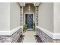 Inviting front door framed by stone accents and lovely plants at 5313 Halewood Ct, Bradenton, FL 34211