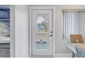 Charming front door with glass panel offering views of the outside from the beautifully decorated interior at 5892 17Th W St # C25, Bradenton, FL 34207