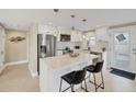 Bright kitchen featuring a quartz island with seating, stainless steel appliances, and modern cabinetry at 6140 Midnight Pass Rd # A10, Sarasota, FL 34242