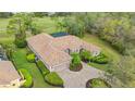 Lovely home with a tile roof, screened in lanai, paver driveway, lush landscaping and attached two-car garage at 7849 Wilton Crescent Cir, University Park, FL 34201