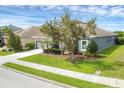 Attractive single-story home featuring a landscaped yard and gray siding, taken from the side at 815 Rosemary Cir, Bradenton, FL 34212