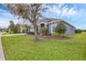 Charming single-story home with a gray exterior, well-maintained lawn, and tasteful landscaping at 815 Rosemary Cir, Bradenton, FL 34212