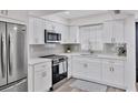 Bright kitchen with white cabinets, quartz countertops, and modern appliances at 102 46Th Avenue W Ter # 402, Bradenton, FL 34207