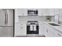 Modern kitchen featuring stainless steel appliances and white cabinets at 102 46Th Avenue W Ter # 402, Bradenton, FL 34207