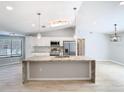 Bright kitchen with a center island, stainless steel appliances, and ample counter space at 13365 Drayton Dr, Spring Hill, FL 34609