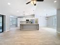 Spacious open floorplan with vaulted ceilings, a kitchen island, and tile flooring at 13365 Drayton Dr, Spring Hill, FL 34609