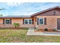 Close up of a single-Gathering home with a brick facade and manicured landscaping at 1622 17Th E St, Bradenton, FL 34208