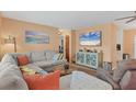 Bright living room with a comfortable sectional sofa and a mounted television at 1622 17Th E St, Bradenton, FL 34208