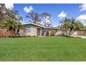 Charming single-story home with well-kept lawn, mature landscaping, and inviting curb appeal at 3053 Concord St, Sarasota, FL 34231
