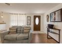 Inviting living room featuring hardwood floors, neutral colors, and a decorative front door at 3053 Concord St, Sarasota, FL 34231