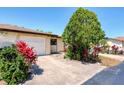 Exterior of a home with an attached garage, driveway, and lush landscaping at 3208 Vivienda Blvd, Bradenton, FL 34207