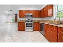 This kitchen has wood cabinets, granite countertops, and stainless steel appliances at 3296 Tallywood Ct # 7097, Sarasota, FL 34237