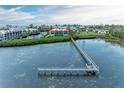 Scenic view of the condos waterfront property with a long wooden pier at 3805 E Bay Dr # 301, Holmes Beach, FL 34217