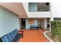Inviting common area with benches, and a decorative sun on the wall at 3805 E Bay Dr # 301, Holmes Beach, FL 34217