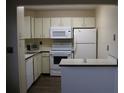 Kitchen with white appliances, plenty of cabinets and an eat-in bar area at 4460 Ironwood Cir # 505Ad, Bradenton, FL 34209
