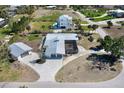 An aerial view of a beautiful home featuring a screened in patio, extra garage, and detailed driveway at 45 Cape Haze Dr, Placida, FL 33946