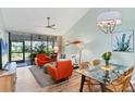 Cozy living room with vaulted ceilings, stylish furnishings, and sliding glass doors to the lanai at 4569 Morningside # 18, Sarasota, FL 34235