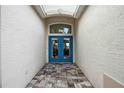 A view of the double front door with a window above and a tiled walkway, creating an inviting entrance at 5112 52Nd W Ave, Bradenton, FL 34210