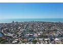 Stunning aerial view of a waterfront property, with a boat dock, situated on a canal leading to the ocean at 5169 Sandy Shore Ave, Sarasota, FL 34242