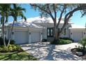 Beautiful single-story home with a light gray trim, metal roof, and a charming, well-maintained front yard at 5169 Sandy Shore Ave, Sarasota, FL 34242