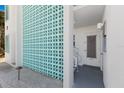 Condo entrance with turquoise block wall and steps to the front door at 5400 Gulf Dr # 25, Holmes Beach, FL 34217