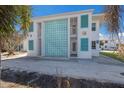 Exterior view of the condo with turquoise block wall and shutters at 5400 Gulf Dr # 25, Holmes Beach, FL 34217