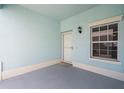 View of the tiled patio space outside the unit's front door with a window at 5743 Sabal Trace Dr # 101B57, North Port, FL 34287