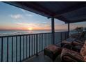 Relaxing balcony view with comfortable seating and a stunning ocean sunset at 6700 Gulf Dr # B8, Holmes Beach, FL 34217