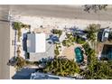 Aerial shot showcasing a private backyard pool surrounded by lush landscaping at 701 N Bay Blvd, Anna Maria, FL 34216