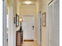 Inviting hallway with neutral tones, tiled floor, and tasteful decor at 8403 Grand Estuary Trl # 103, Bradenton, FL 34212